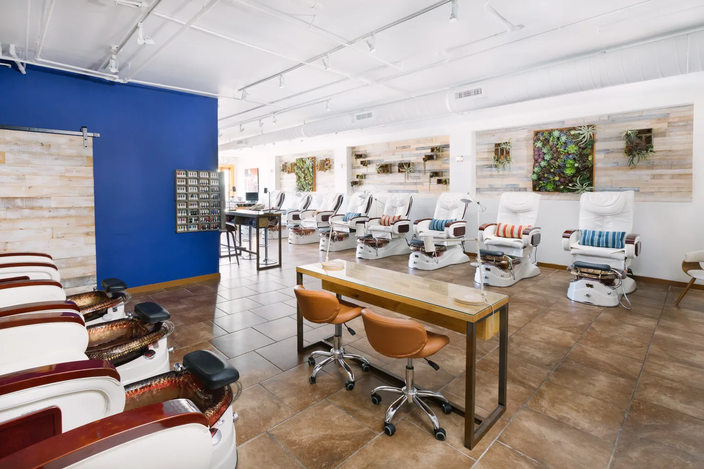 The actual Venice Soleil nail salon, with bright blue walls and sunlit pedicure chairs